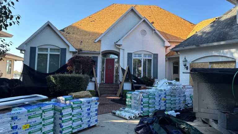 Roof replacement setup protecting a garage door and landscaping at a Central Indiana home